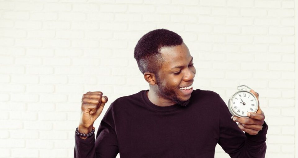 young-black-man-with-alarm-clock_93675-39198